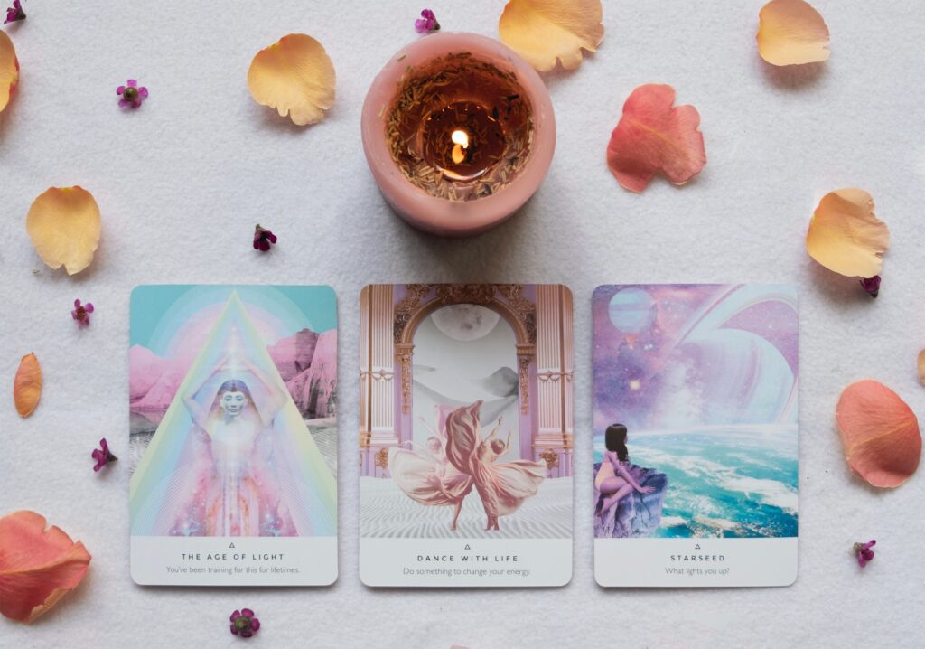 Oracle cards and a candle with flower petals